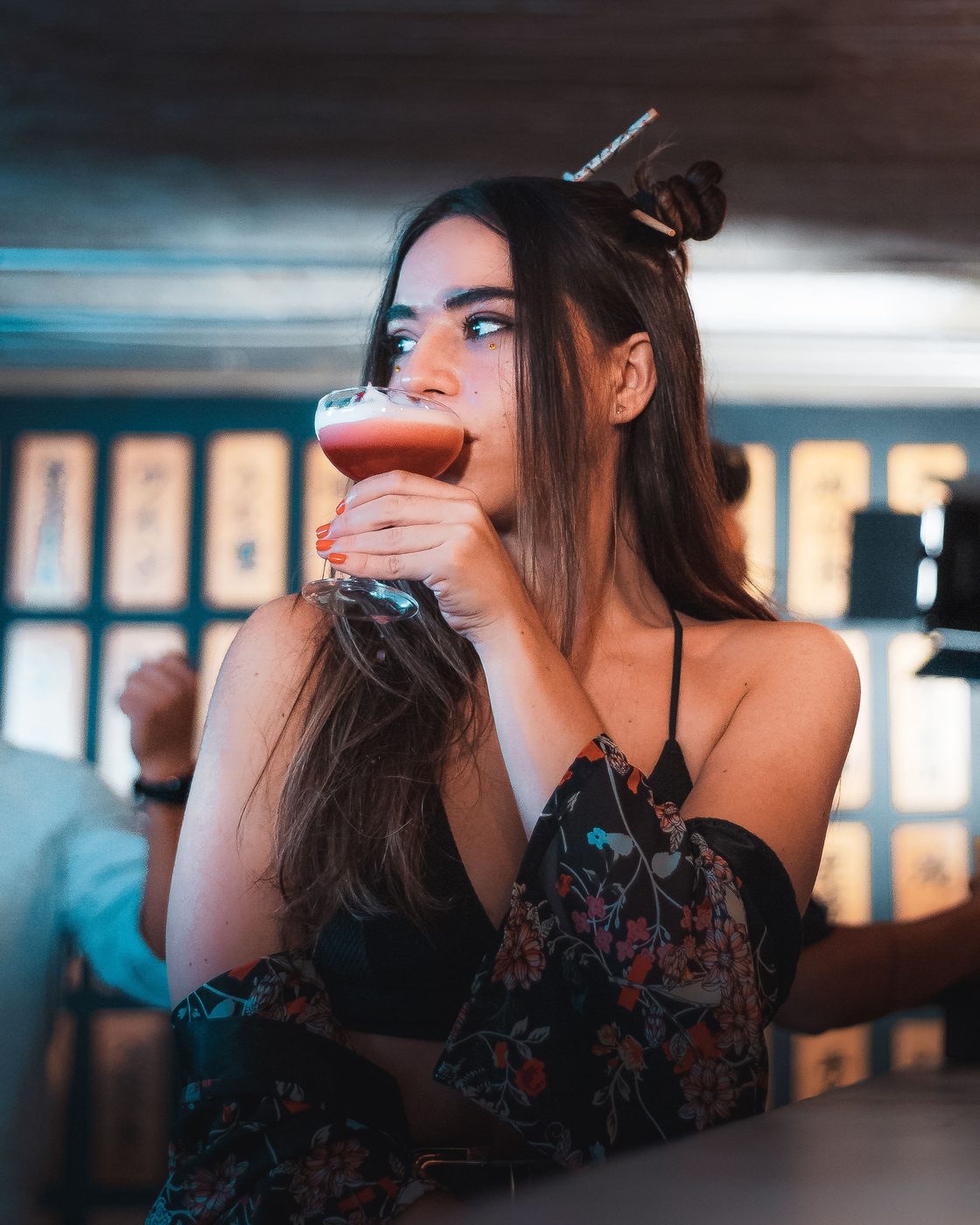 Guest drinking a cocktail at an evening celebration