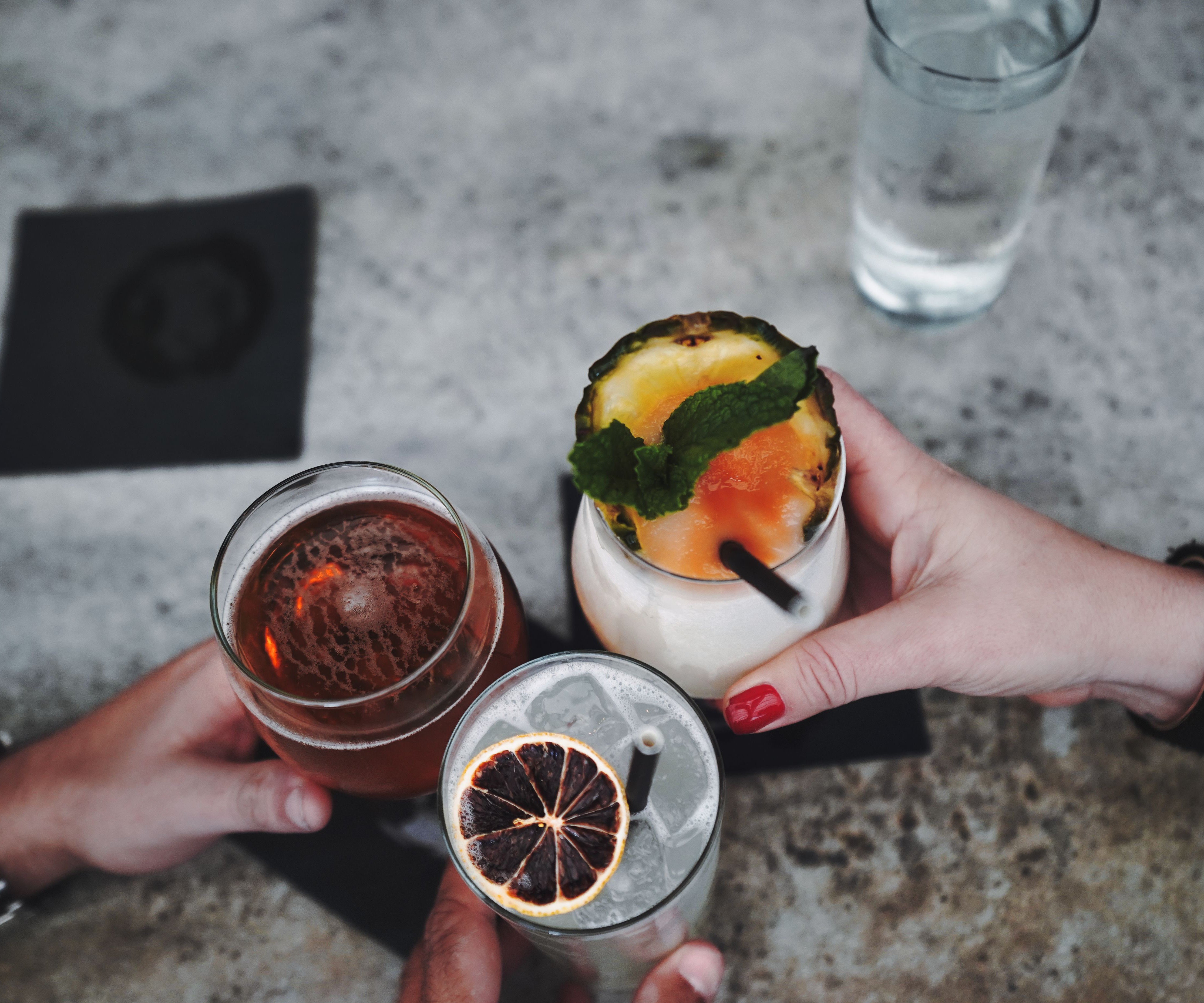 Cocktails being shared over a bar counter