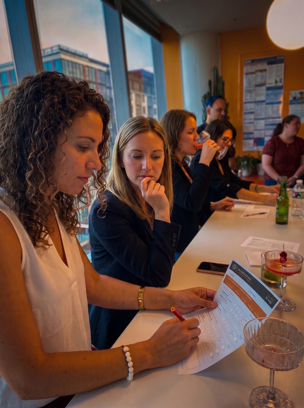 Judges scoring a cocktail with a criteria card
