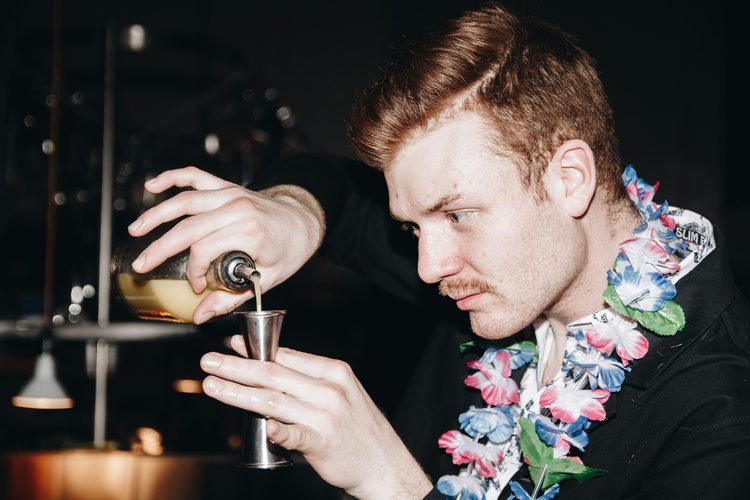 Woman drinking a pink cocktail