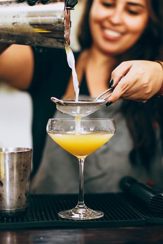 Friends toasting cocktails at golden hour