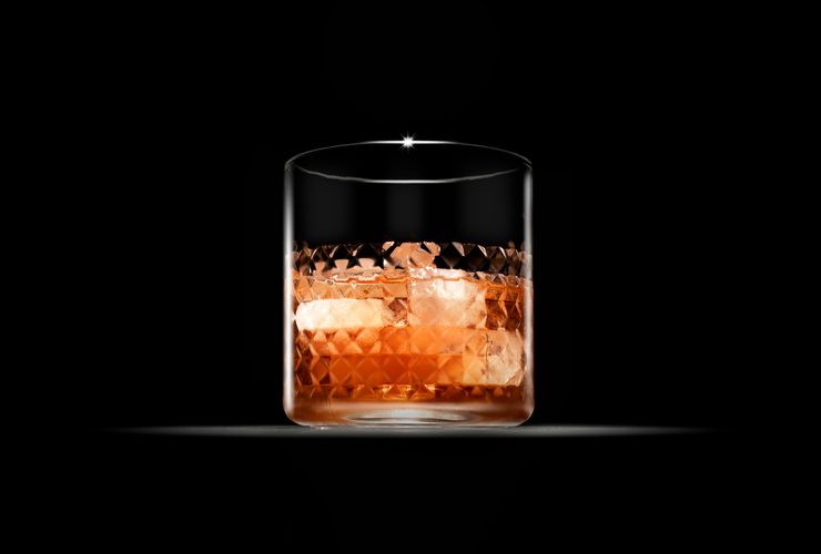 Whiskey glass with a single large ice cube
