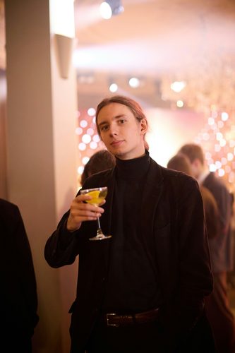 Guest holding a citrus garnished cocktail