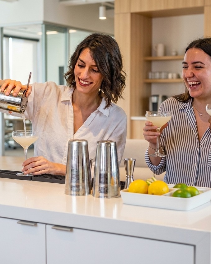 Team members pouring and sharing a cocktail together