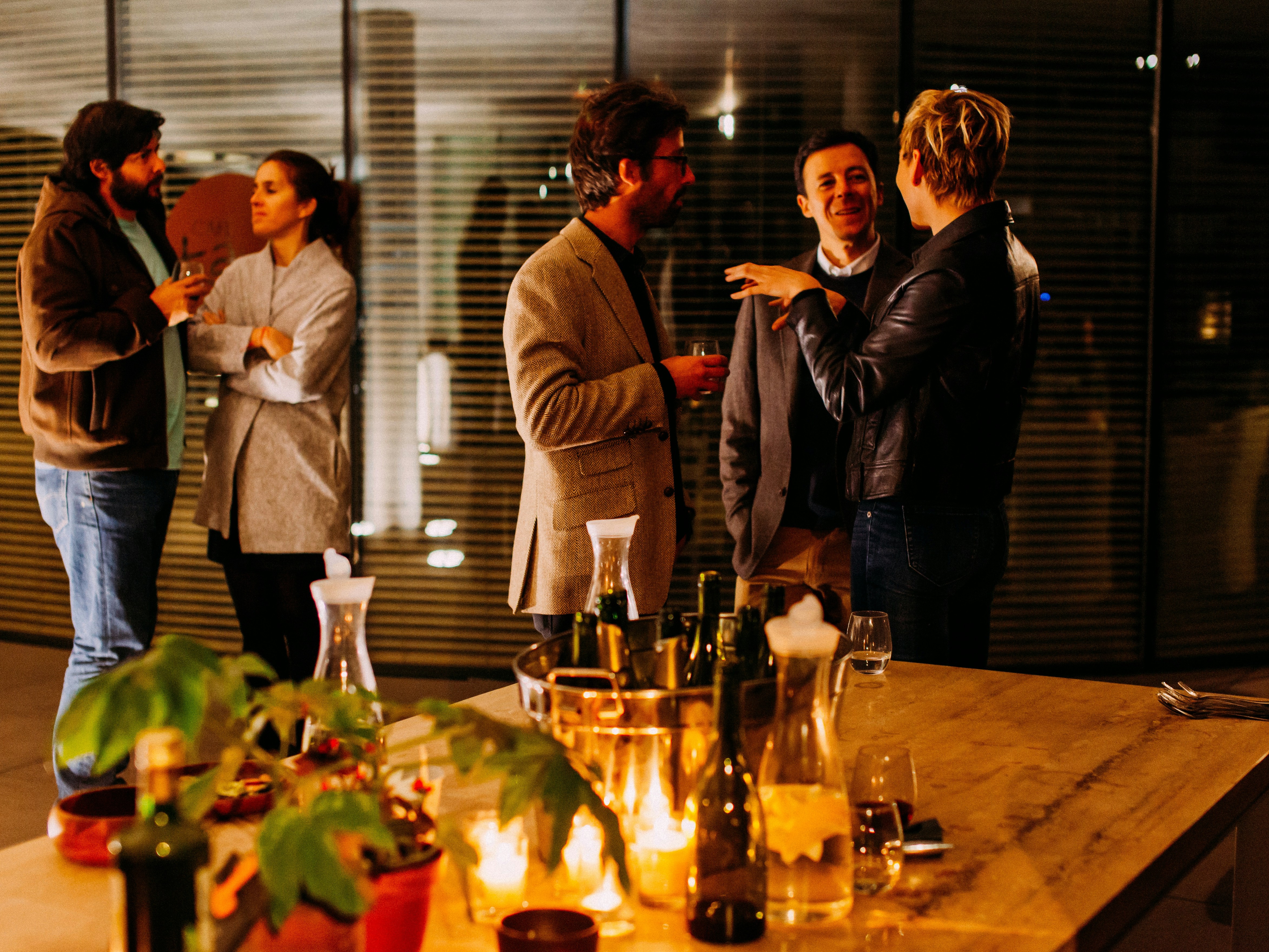 Group socializing with wine at an evening event
